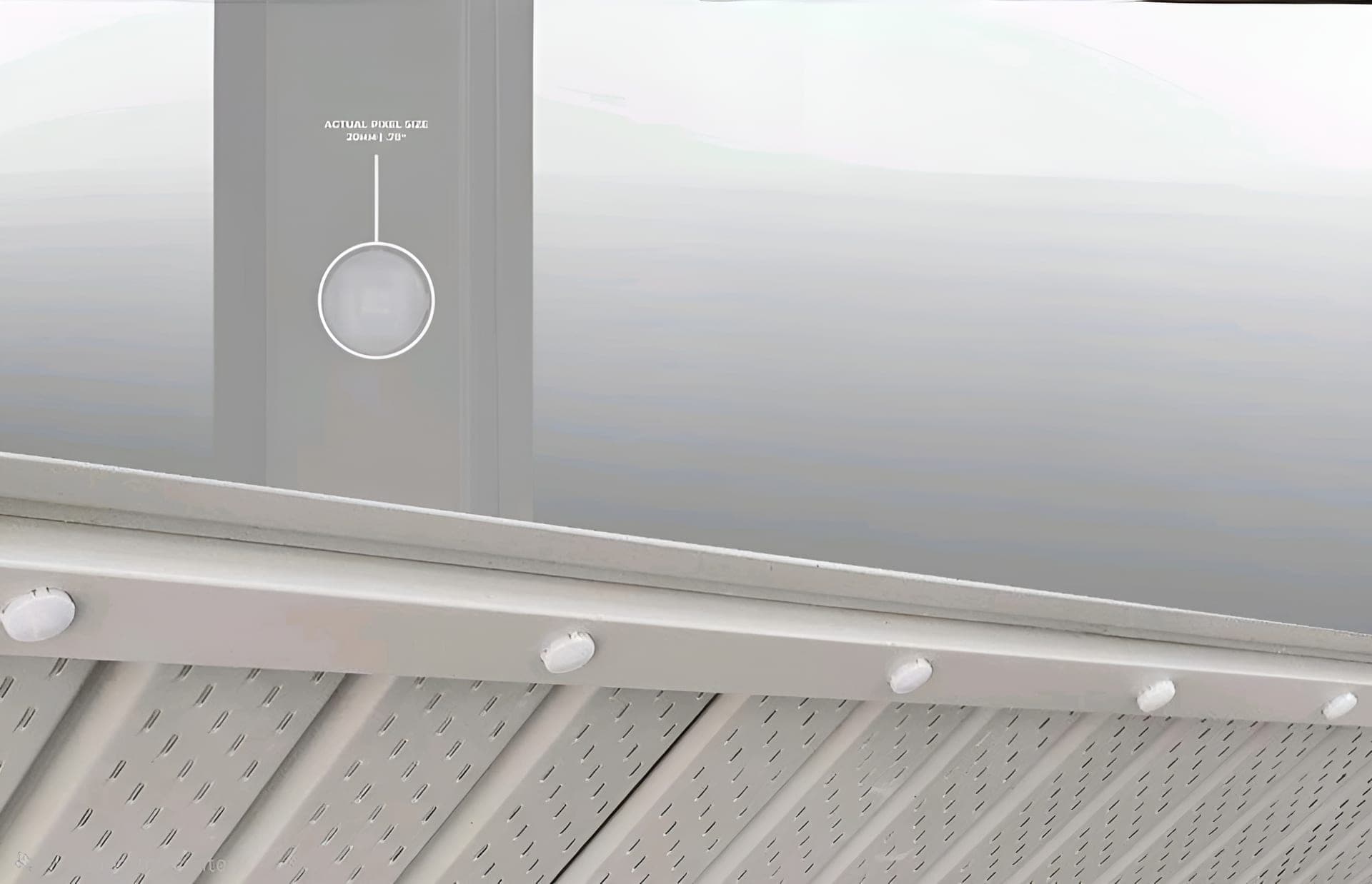 Daytime close-up of a colour-matched permanent lighting track sitting nearly invisible inside a white aluminum soffit