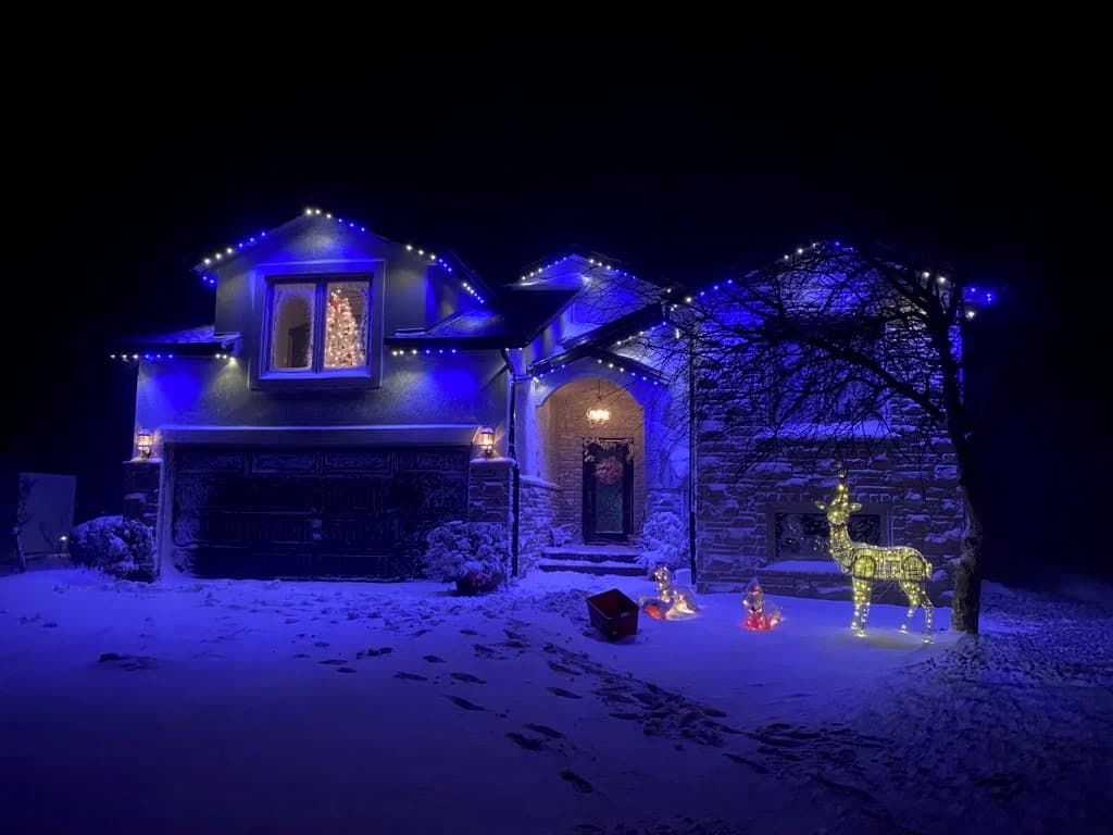 Colour-matched permanent LED track lighting on the roofline of a Tillsonburg, Ontario home at dusk